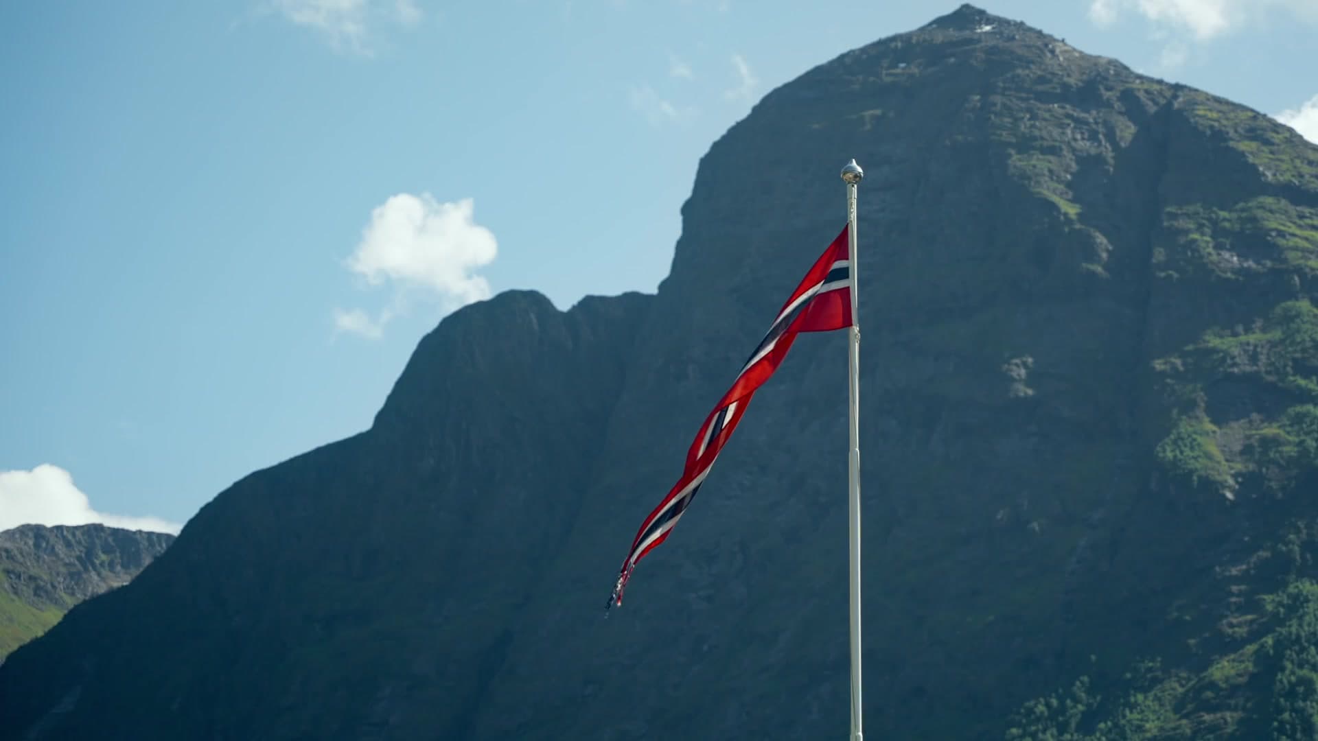 The Norwegian flag against a mountain at the opening of the Chantal film