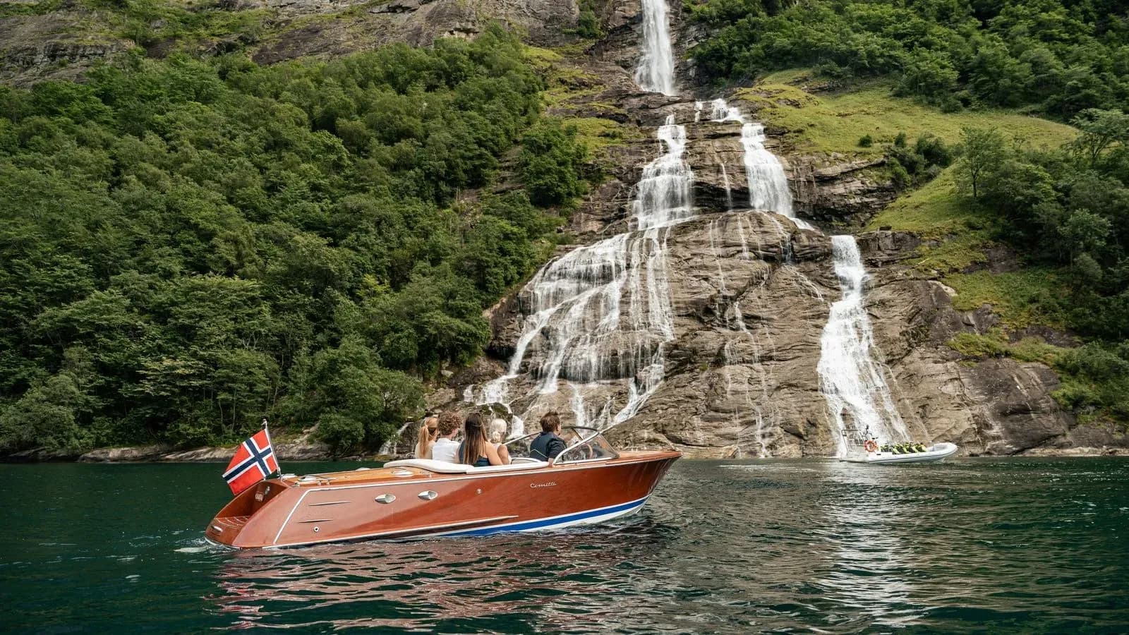 Chantal’s wooden tender passing a waterfall