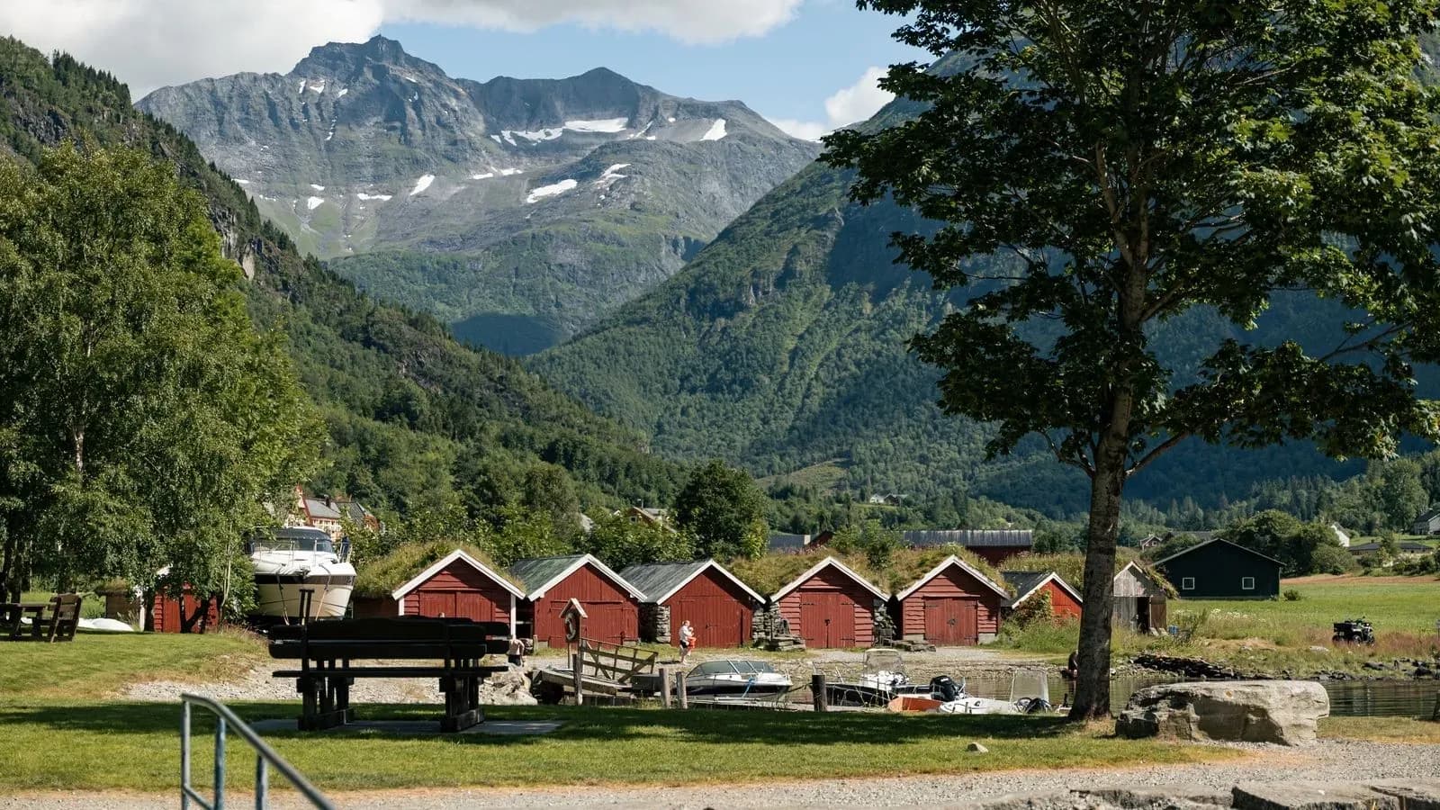 Red boathouses beneath the mountains of a Norwegian fjord village