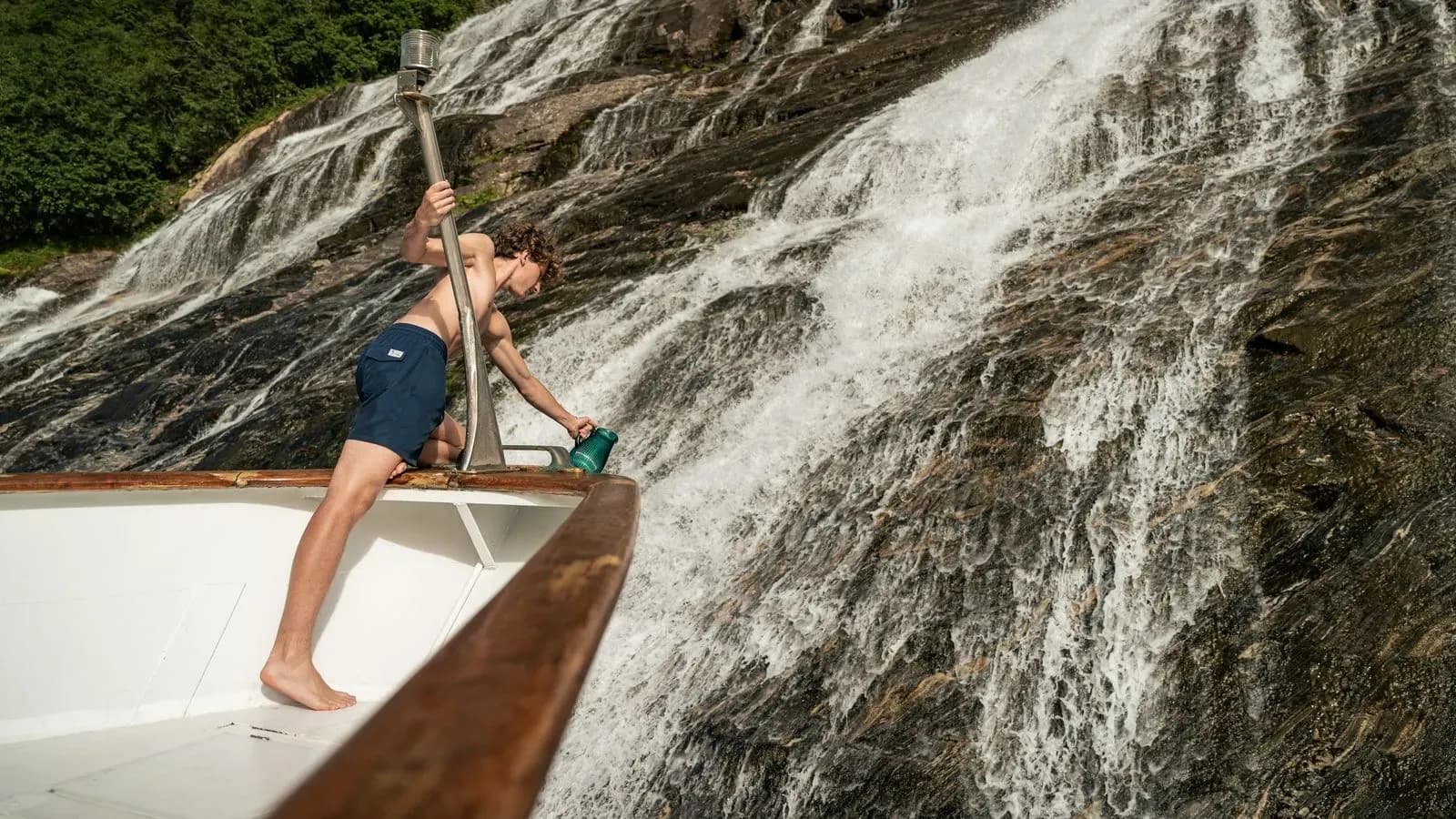 Guest reaching from Chantal’s bow to fill a cup at a waterfall