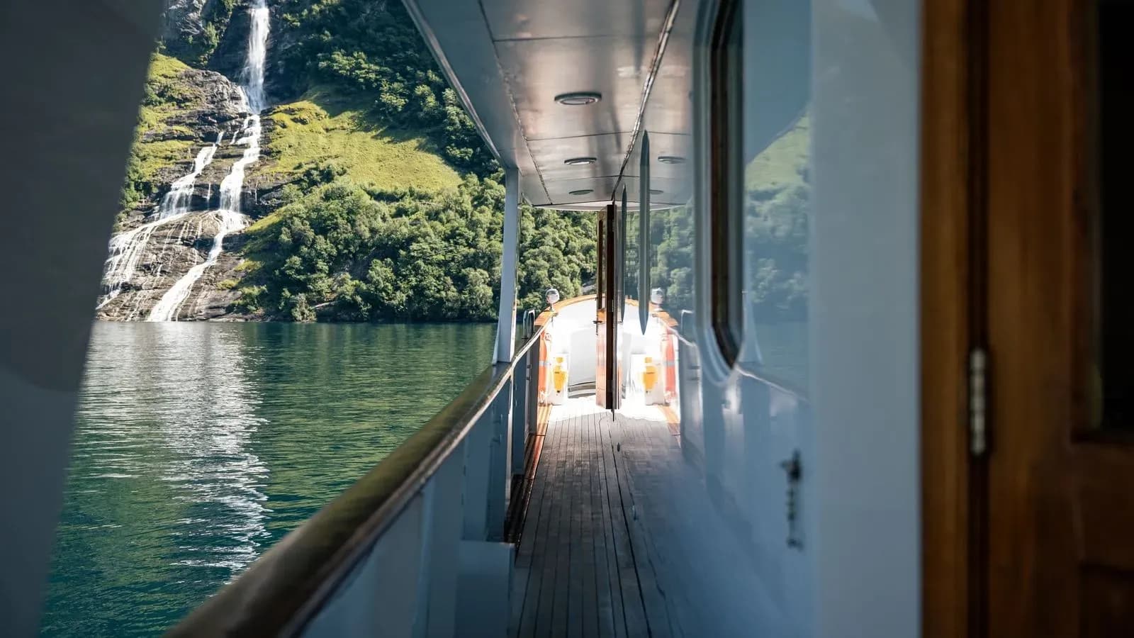 Chantal’s side deck alongside a cascading fjord waterfall