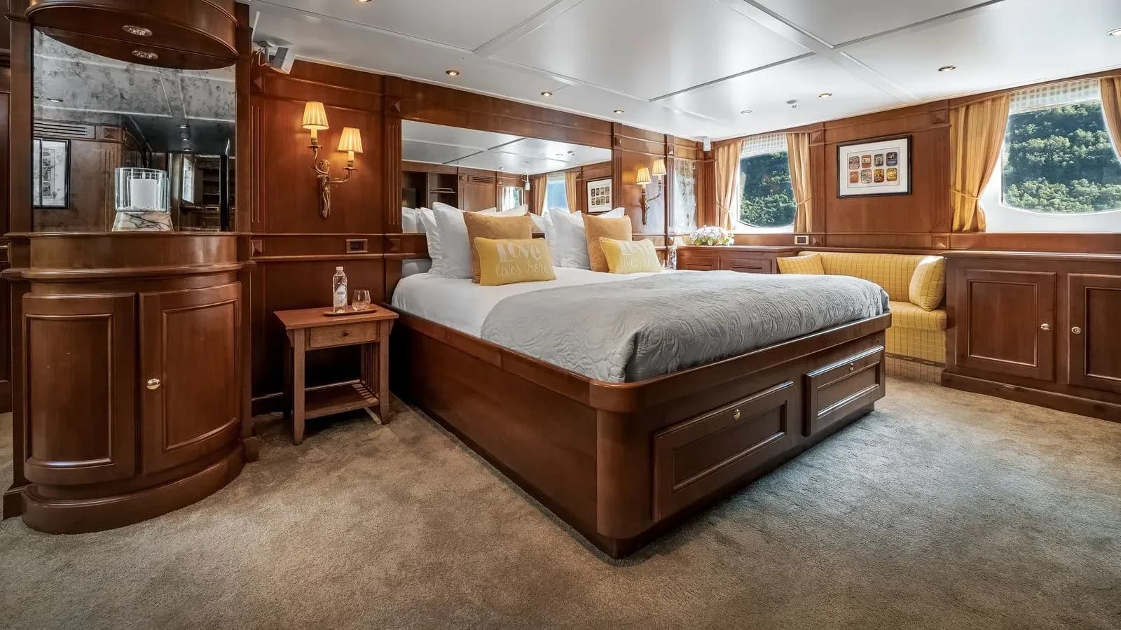 Owner’s suite with double bed and warm wood cabinetry