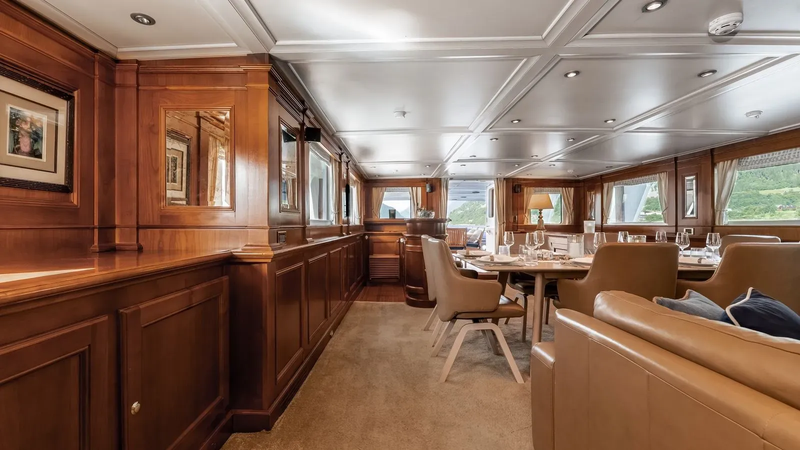 Main salon with dining table and lounge seating