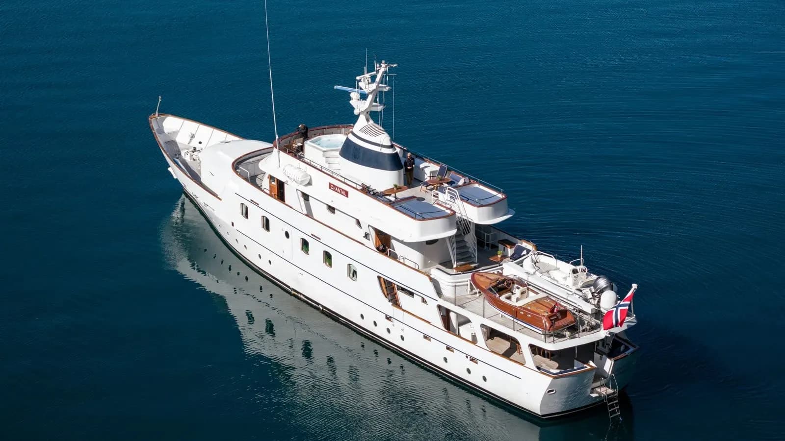 Aerial stern-quarter view of Chantal on calm water