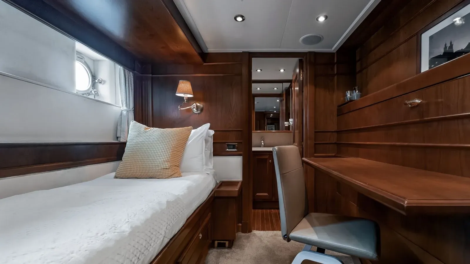 Twin guest cabin with single berth and writing desk