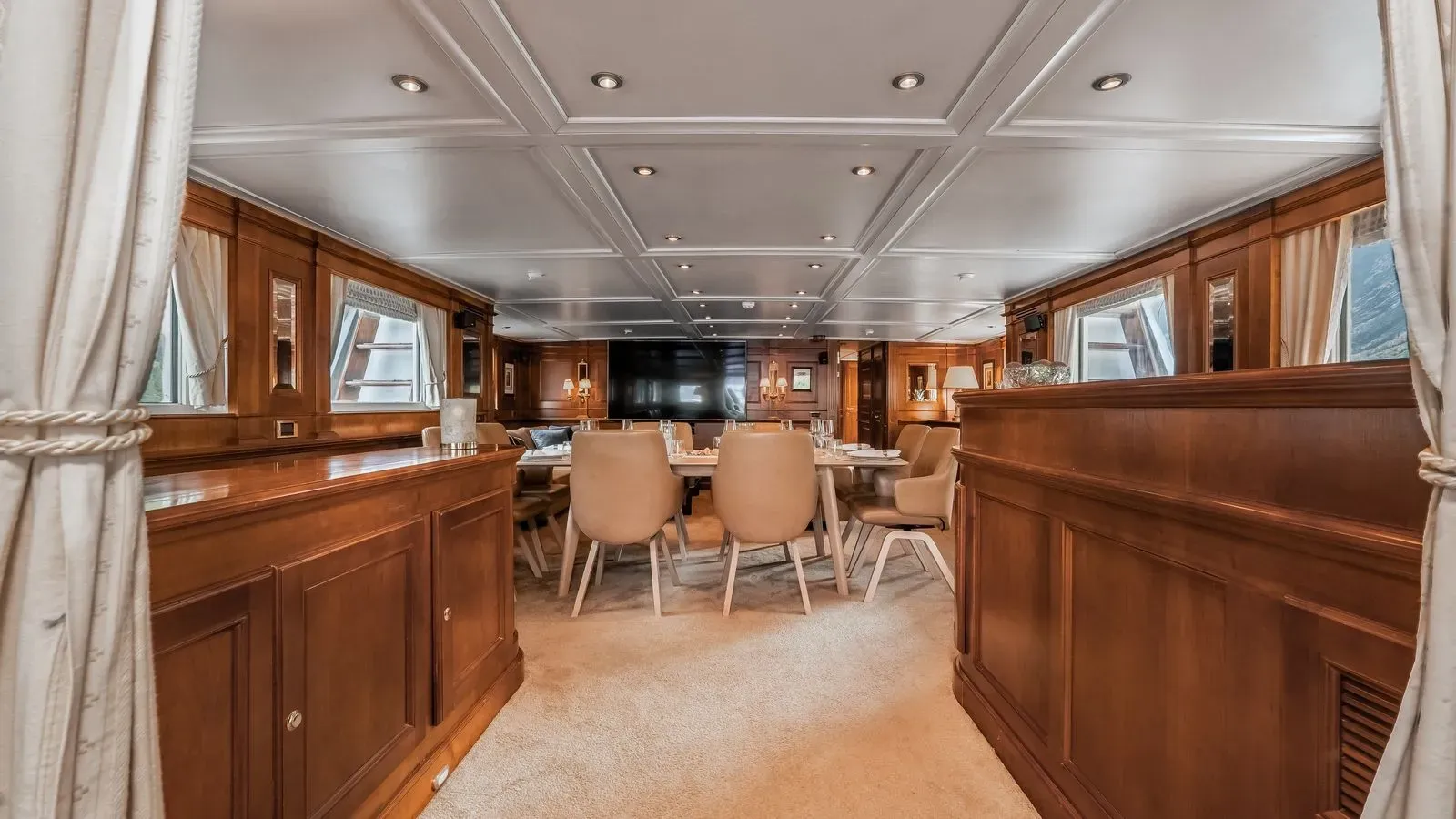 Wood-panelled main salon and dining area aboard Chantal