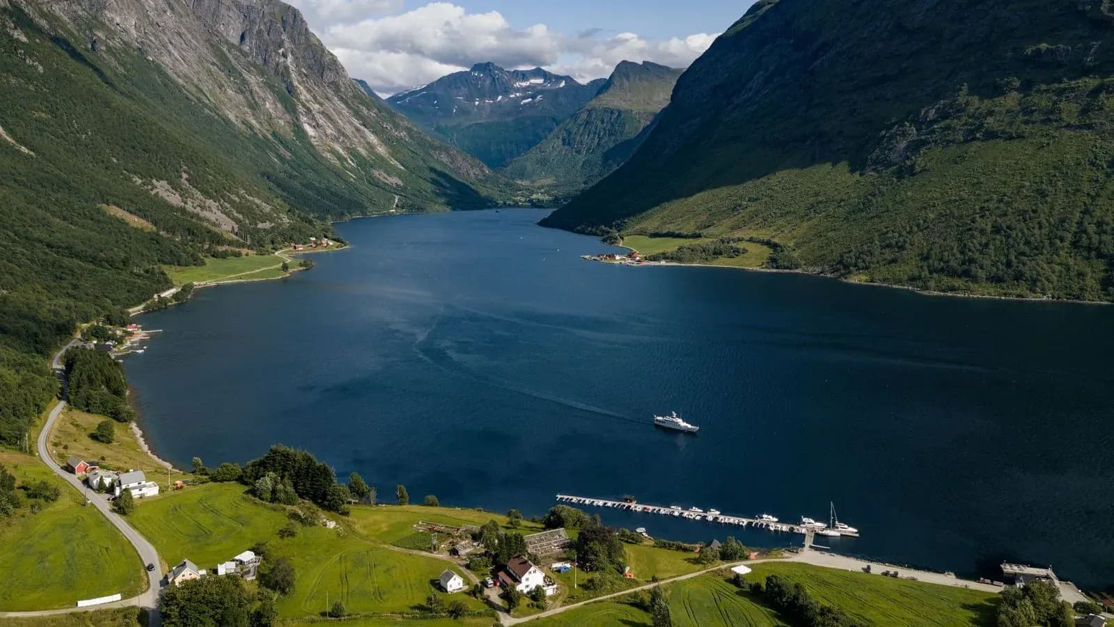 Chantal cruising through a wide Norwegian fjord landscape